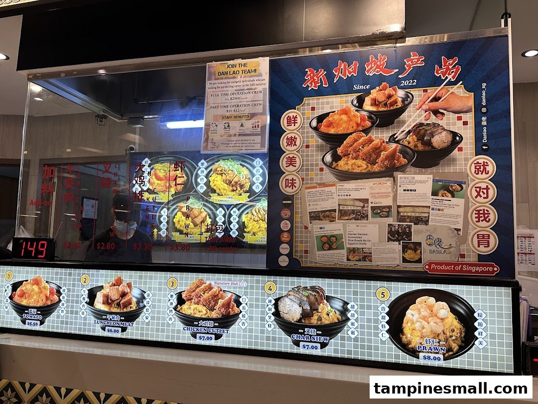 A vibrant display of Dan Lao's signature scrambled egg rice bowls and menu at the ordering counter.