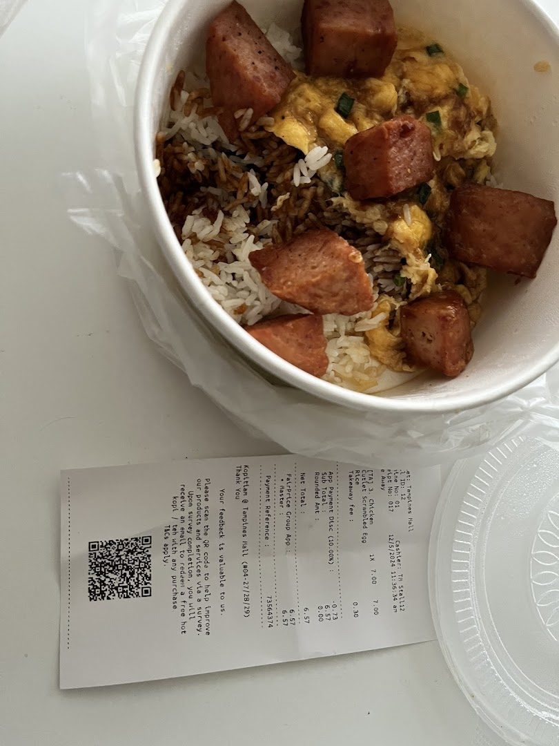 A close-up of a delicious scrambled egg rice bowl with spam, next to a detailed receipt.