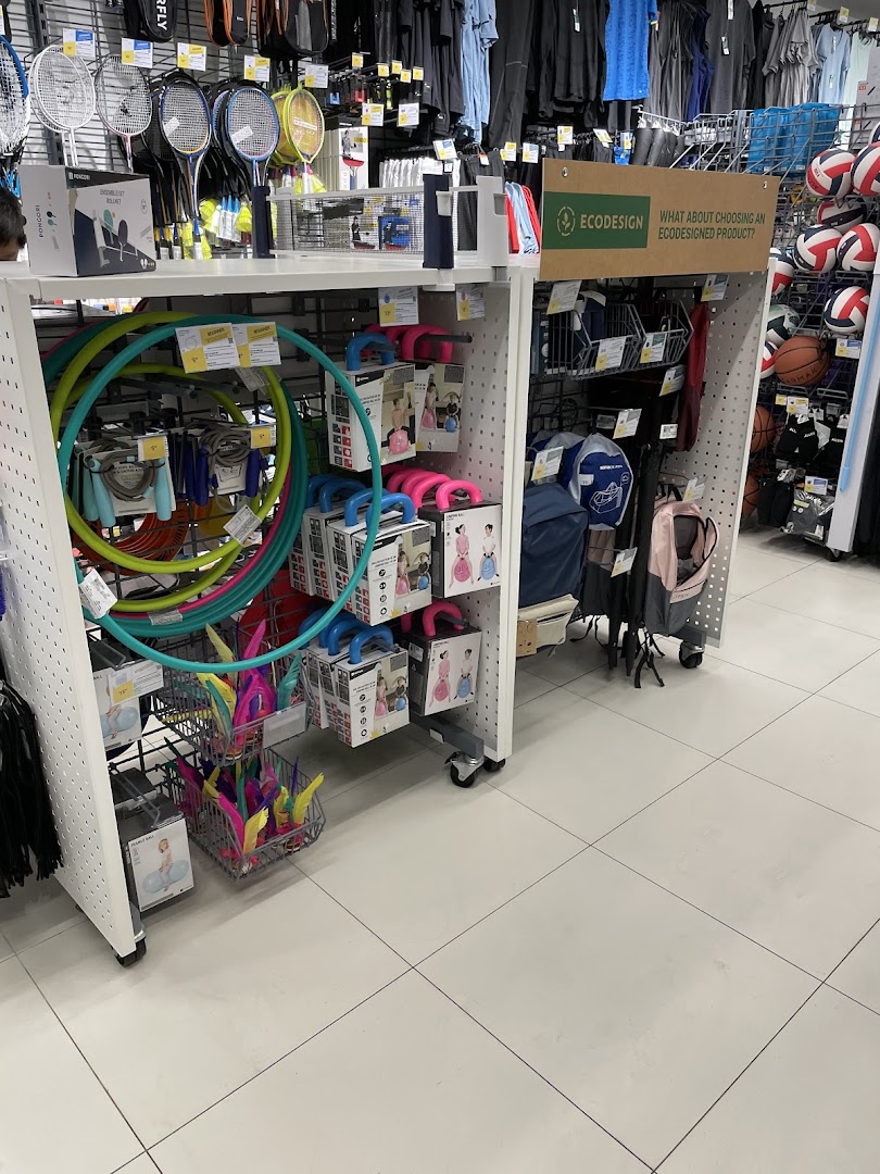 Interior view of Decathlon showcasing a variety of sports equipment including hula hoops, rackets, and balls.