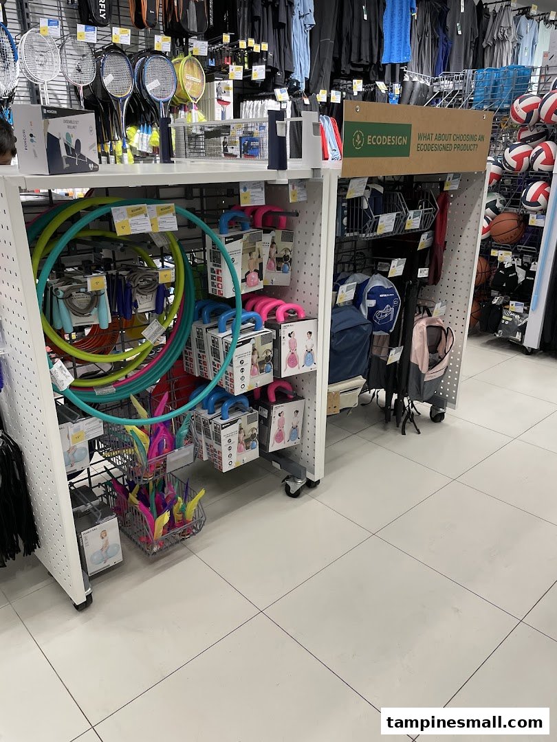 Interior view of Decathlon showcasing a variety of sports equipment including hula hoops, rackets, and balls.