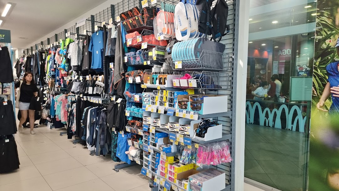 An aisle inside Decathlon showcasing a wide range of sports apparel, swimwear, and accessories.