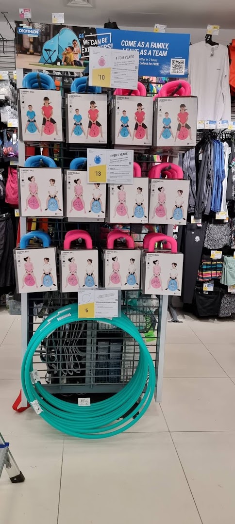 A vibrant display of children's jumping balls and hula hoops at Decathlon.