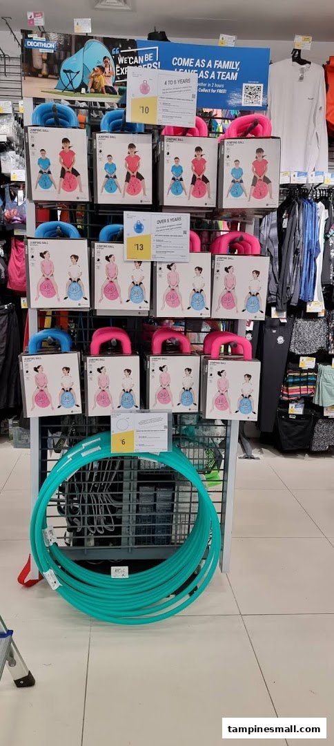 A vibrant display of children's jumping balls and hula hoops at Decathlon.