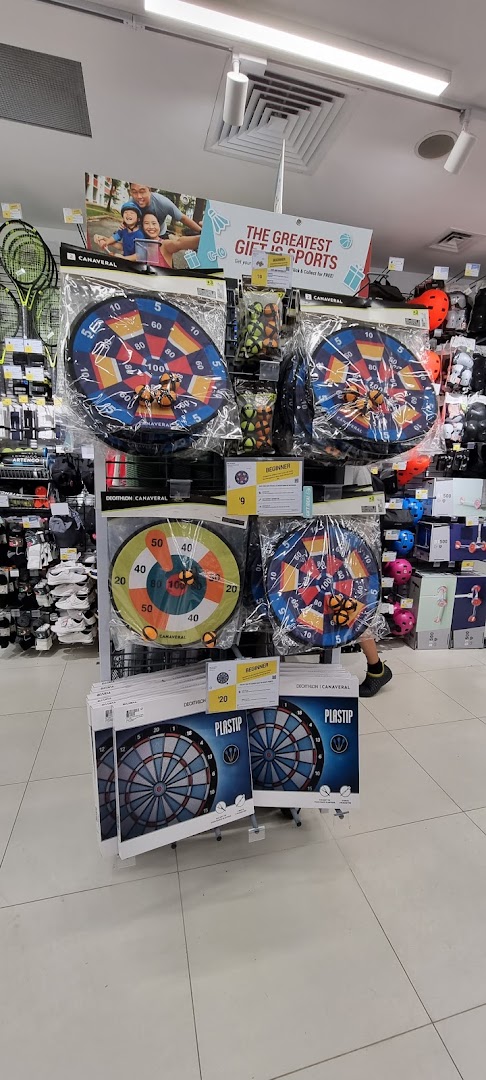 An aisle display at Decathlon featuring various dartboards and sports accessories.