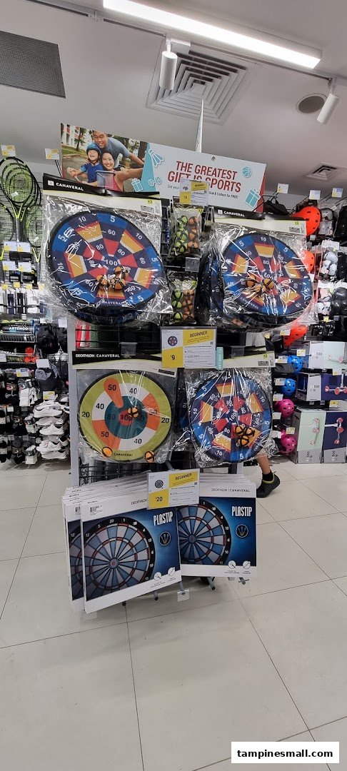 An aisle display at Decathlon featuring various dartboards and sports accessories.