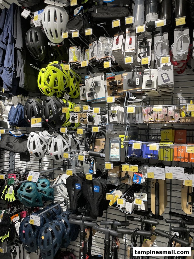 A wall display at Decathlon showcasing a wide range of cycling helmets, accessories, and equipment.
