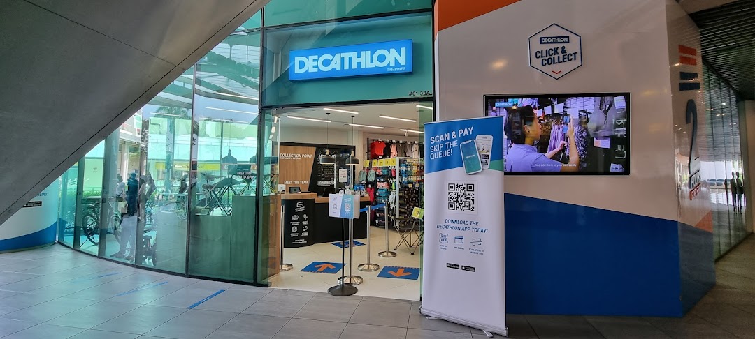Decathlon Tampines store entrance featuring 'Click & Collect' signage and a banner promoting app payment.