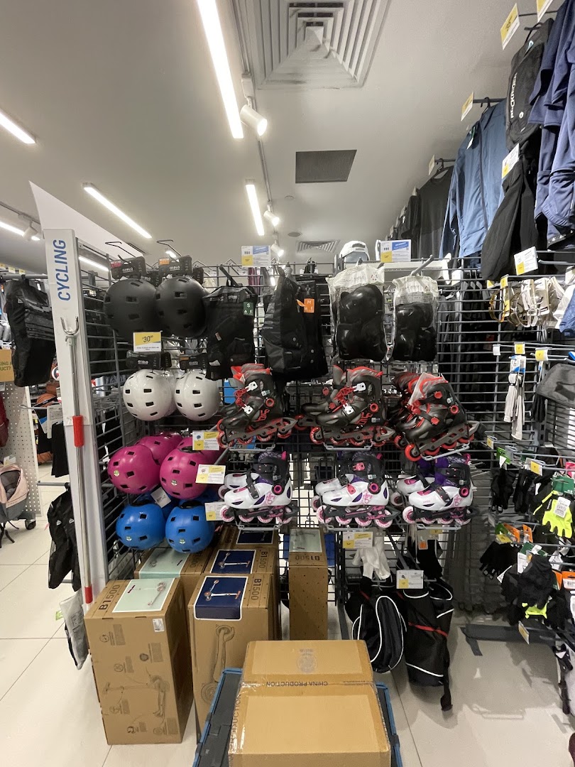 An aisle at Decathlon showcasing rollerblades, helmets, and various sports equipment for active lifestyles.