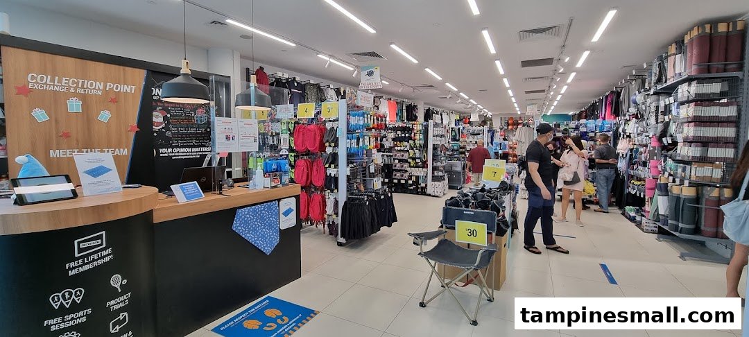 Interior view of Decathlon, showcasing sports equipment, apparel, and a collection point with customers browsing.