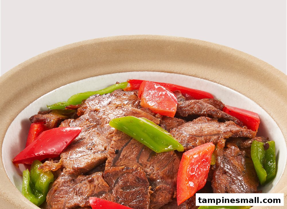 A close-up of a delicious beef dish with vibrant red and green bell peppers.