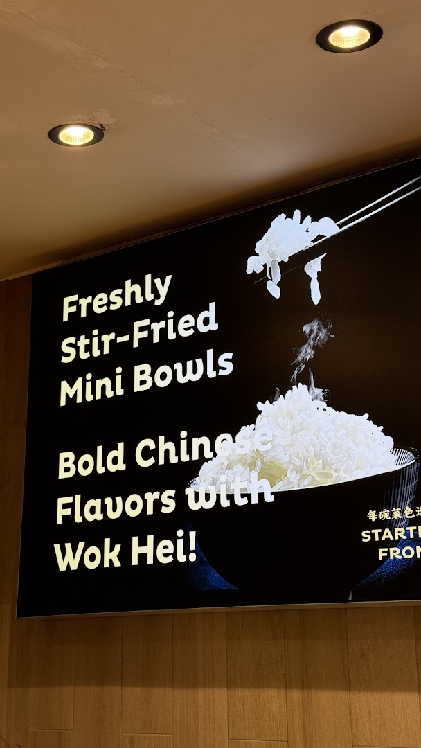 A promotional sign for Delibowl Rice Kitchen highlighting freshly stir-fried mini bowls.