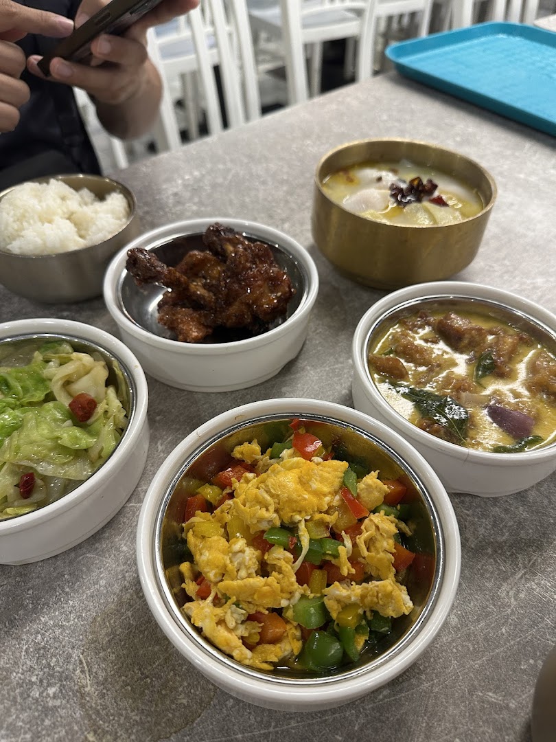 A variety of delicious dishes, including rice, meat, vegetables, and soup, served in small bowls.