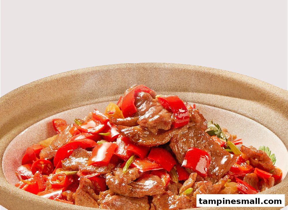 A close-up of a delicious stir-fried meat dish with vibrant red peppers in a rustic bowl.