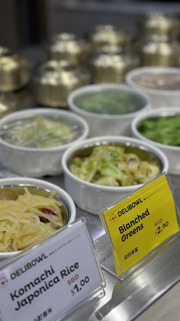 Close-up of Delibowl's side dishes and rice with clear price tags.