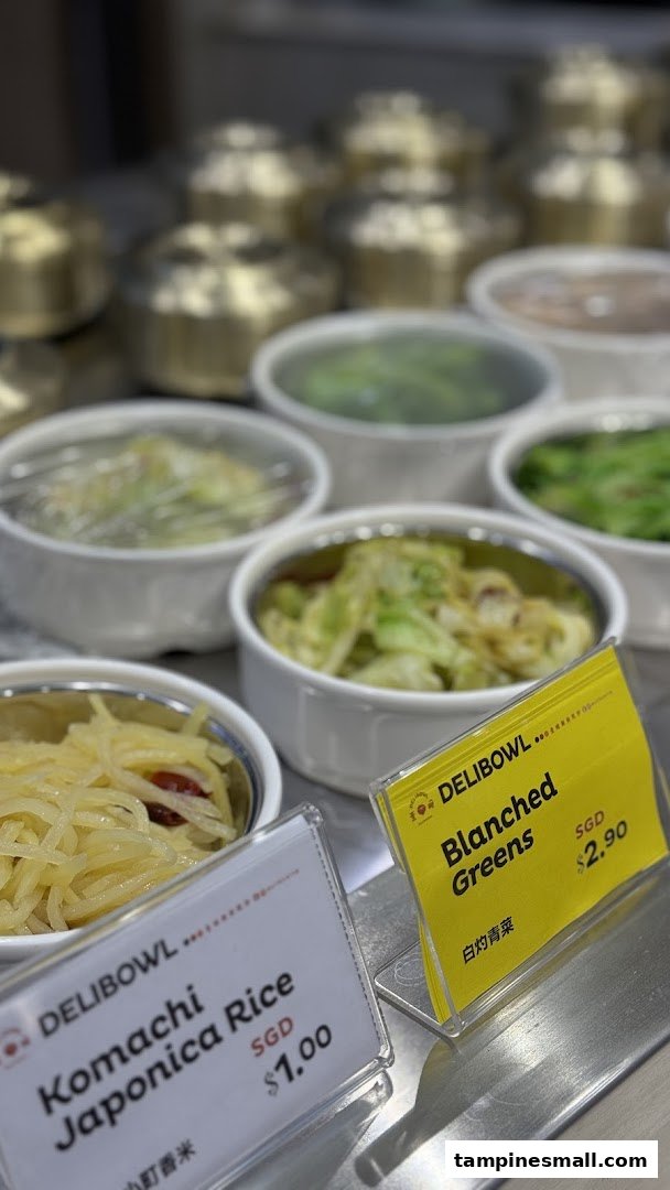 Close-up of Delibowl's side dishes and rice with clear price tags.