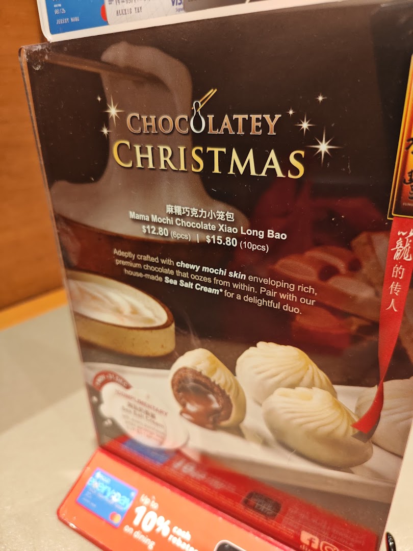 A promotional display for Din Tai Fung's Mama Mochi Chocolate Xiao Long Bao with pricing.