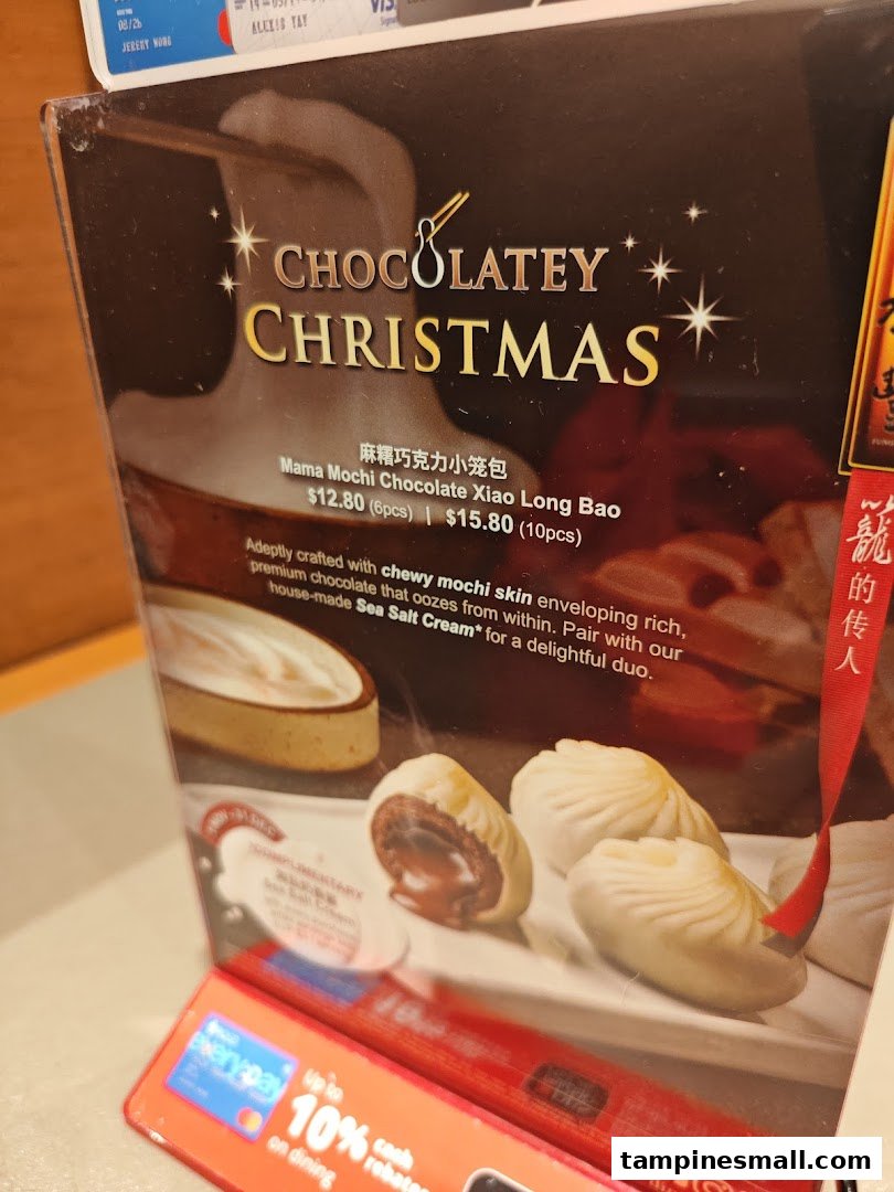 A promotional display for Din Tai Fung's Mama Mochi Chocolate Xiao Long Bao with pricing.