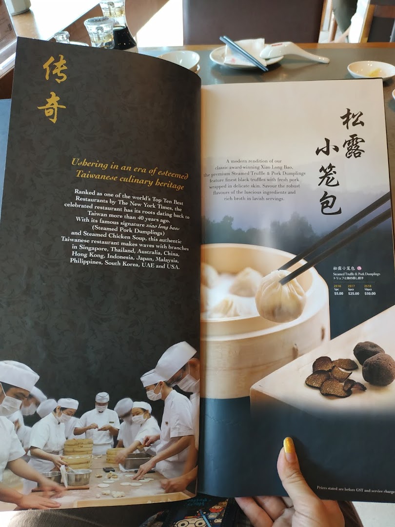 A Din Tai Fung menu displaying information about their heritage and signature truffle dumplings.
