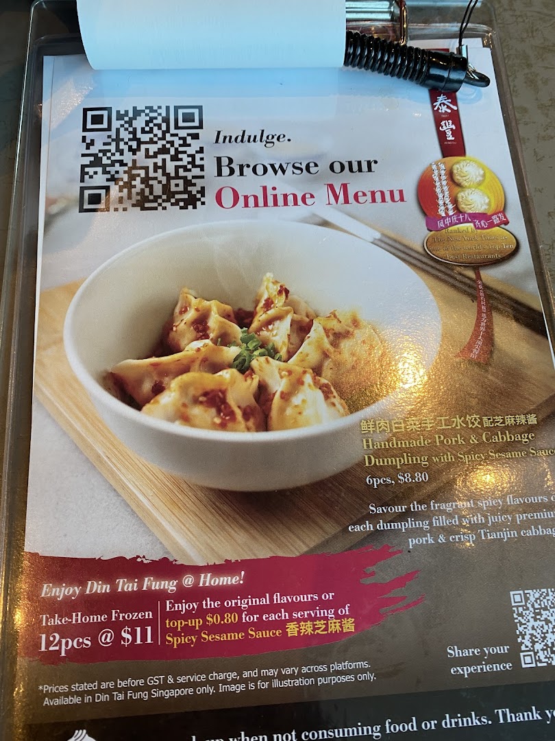 A Din Tai Fung menu display featuring handmade pork & cabbage dumplings and options for online browsing.