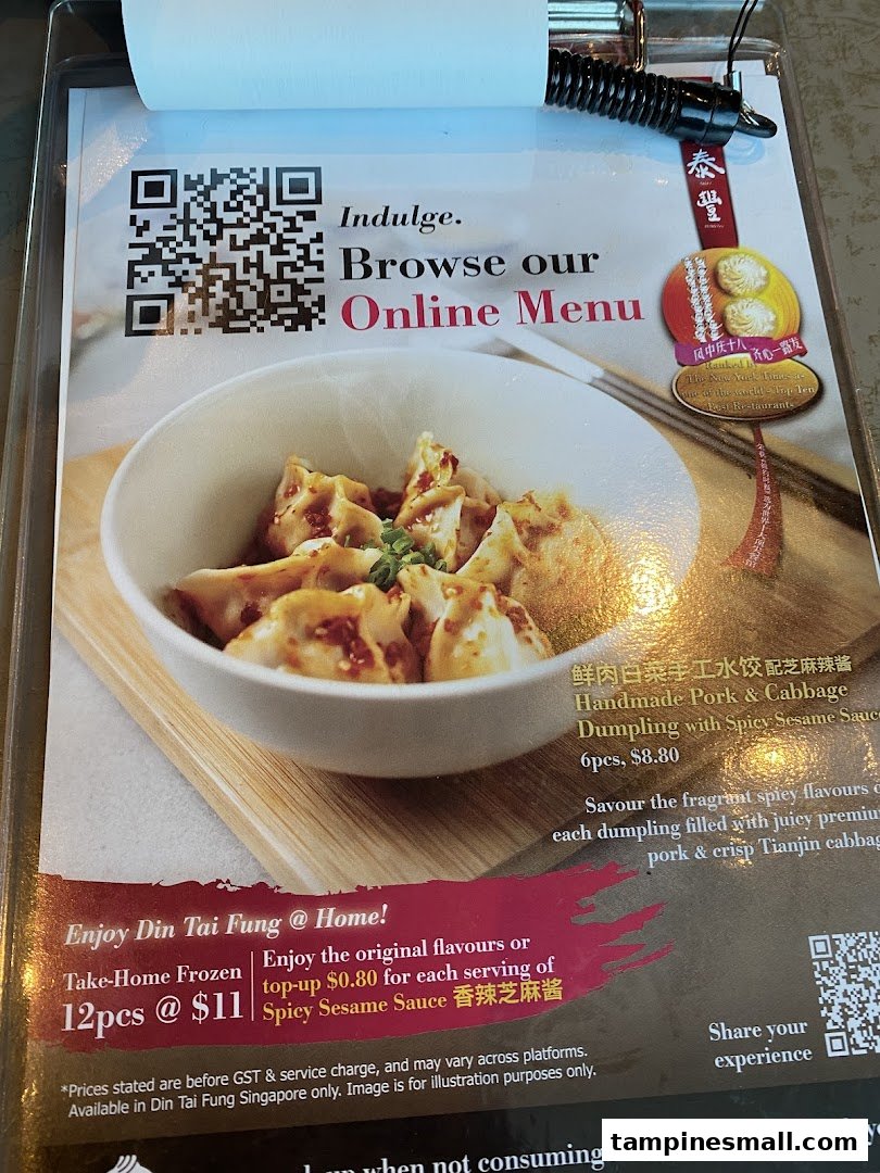 A Din Tai Fung menu display featuring handmade pork & cabbage dumplings and options for online browsing.