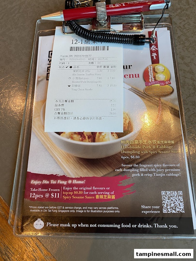 A Din Tai Fung order slip and promotional menu featuring dumplings, noodles, and tea.
