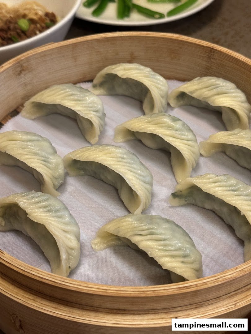 A bamboo steamer filled with freshly steamed dumplings, showcasing Din Tai Fung's culinary delights.