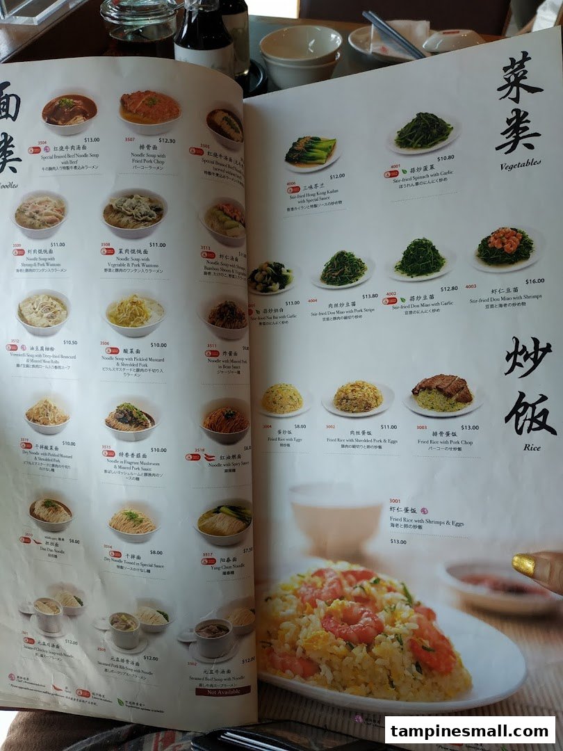 A detailed menu from Din Tai Fung, showcasing a variety of noodles, vegetables, and rice dishes.