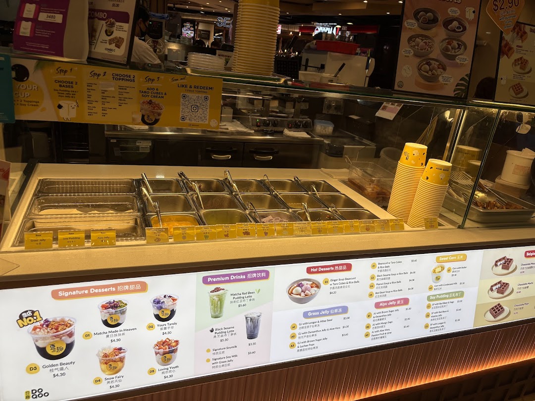 A vibrant display of Do Qoo's dessert counter and extensive menu board featuring various Asian desserts.
