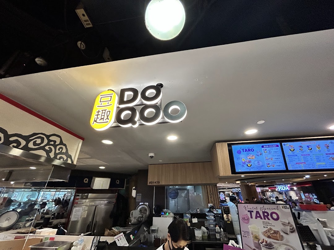 Interior view of Do Qoo 豆趣, showing the counter, shop signage, and a digital menu board.