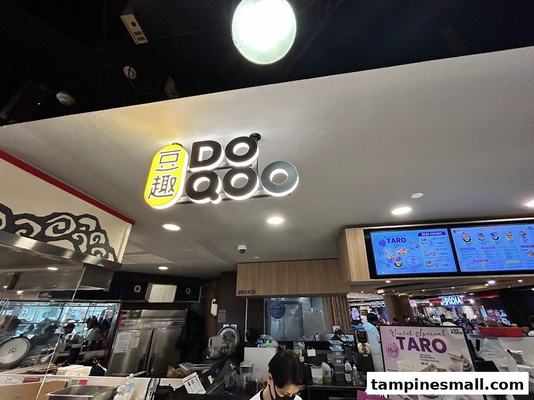 Interior view of Do Qoo 豆趣, showing the counter, shop signage, and a digital menu board.