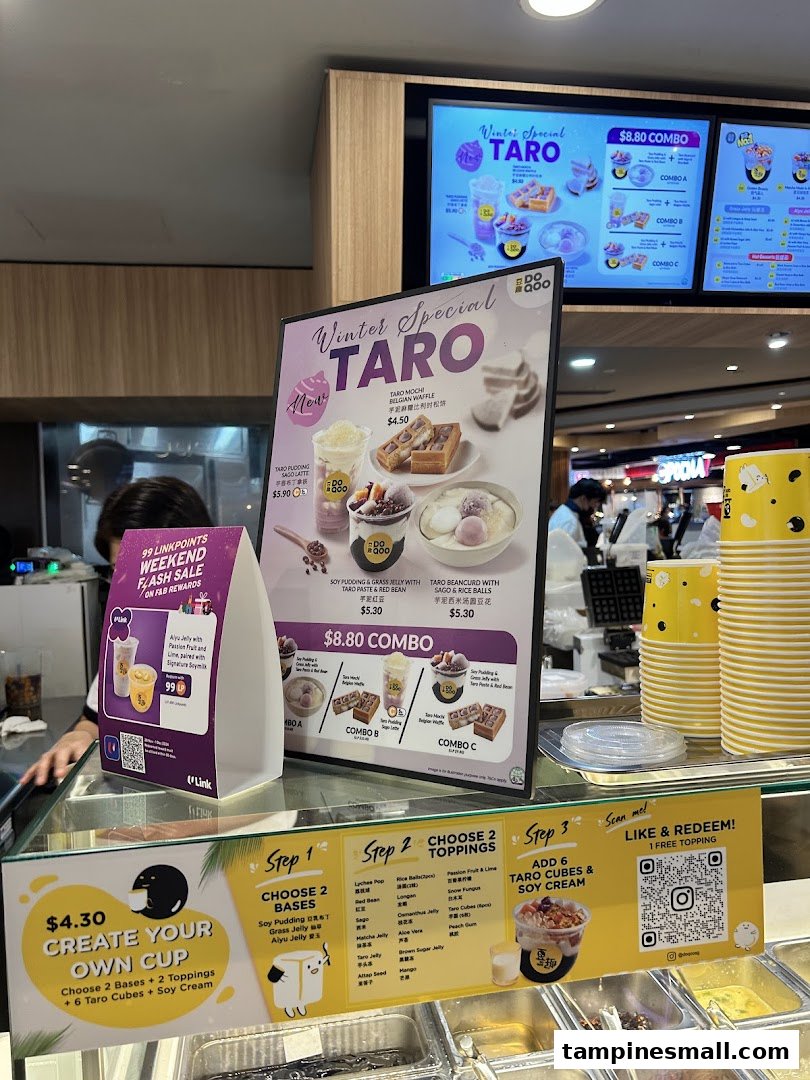 A shop counter displaying various taro-themed desserts and drinks with prominent menu boards.