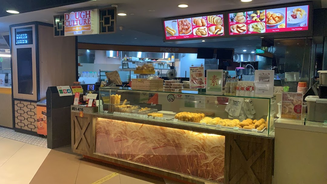 A vibrant counter at Dough Culture showcasing a variety of freshly baked and fried pastries.