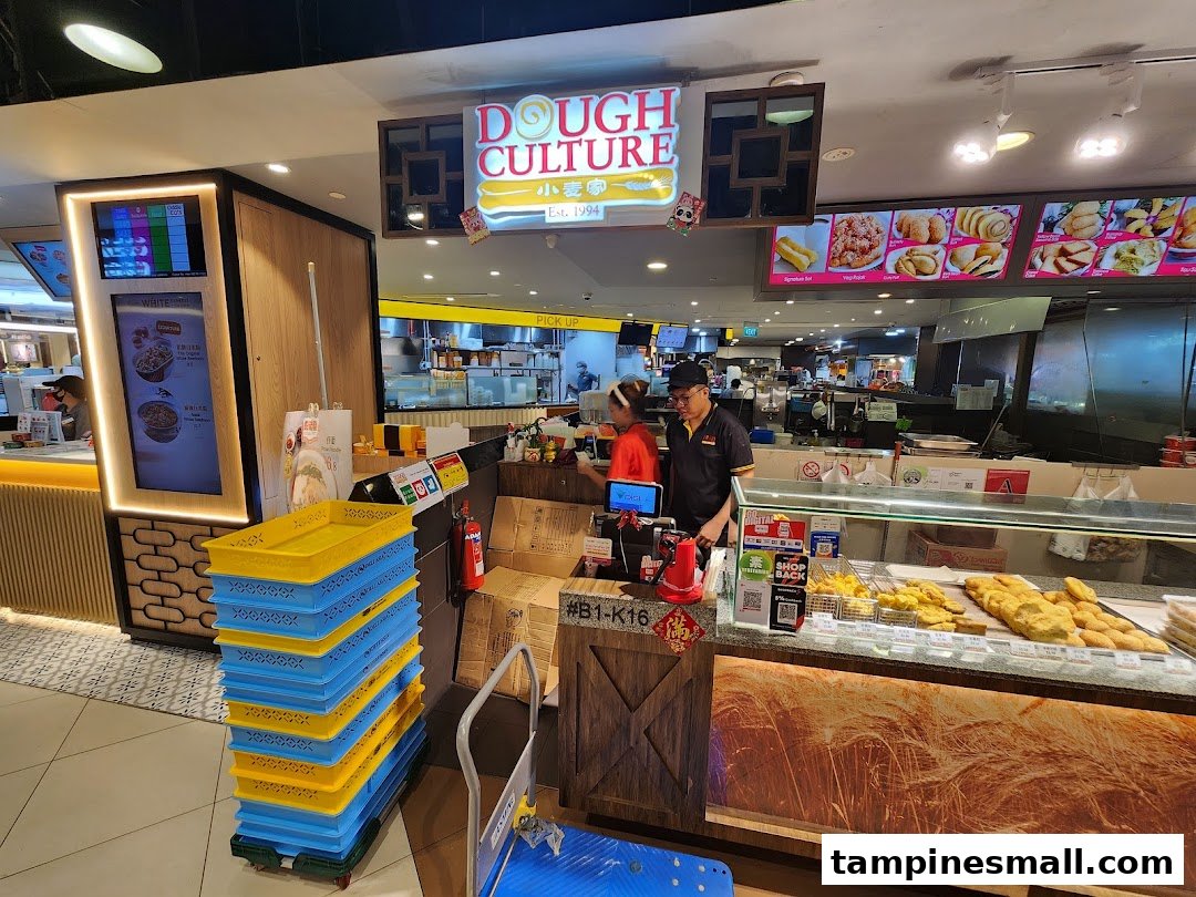 Staff serve customers at Dough Culture, showcasing a display of freshly fried dough products.