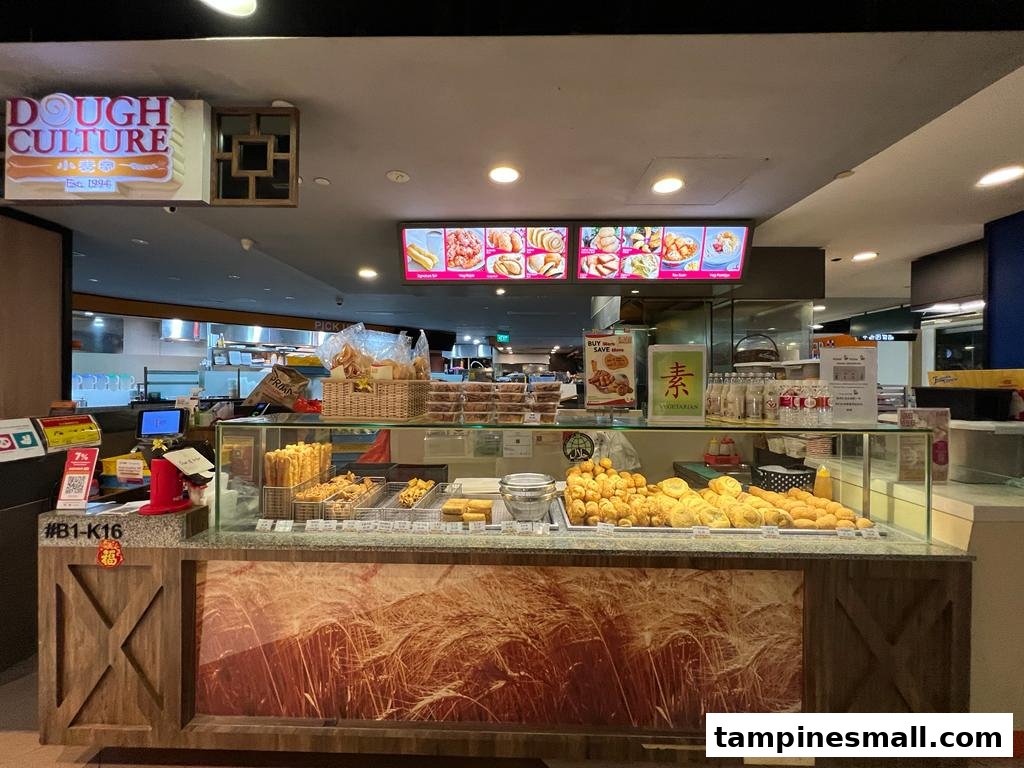 A vibrant display counter at Dough Culture, showcasing a variety of freshly prepared fried dough snacks and pastries.