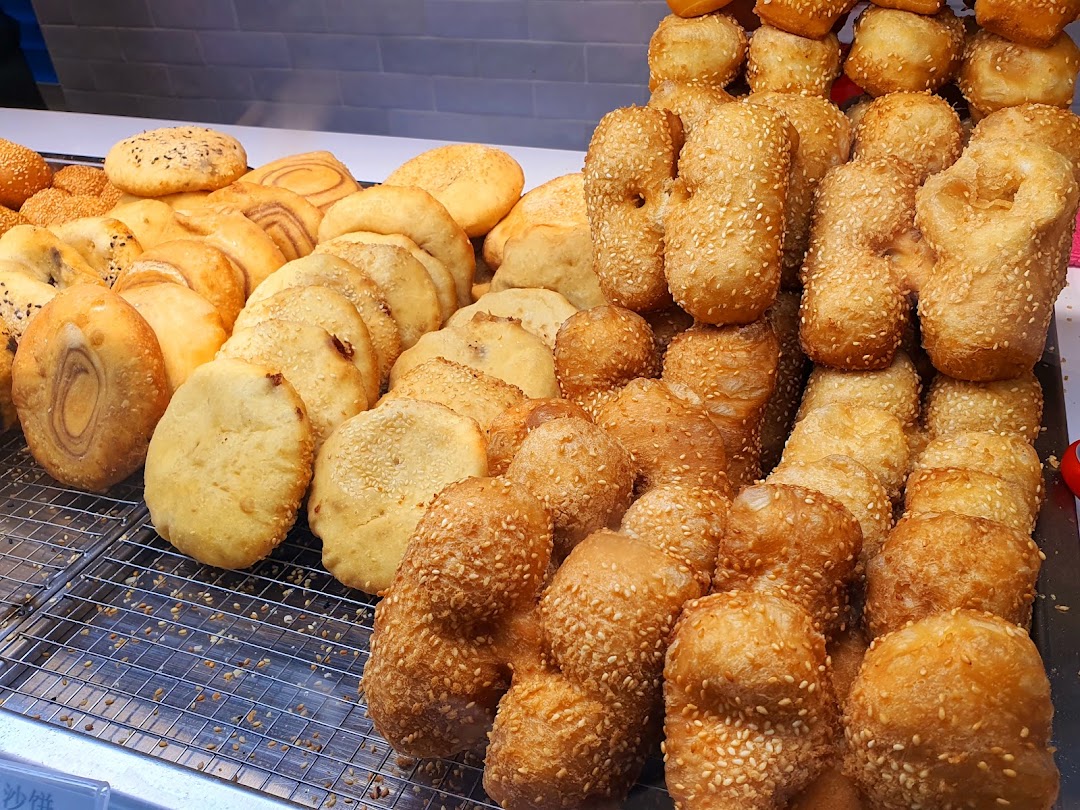 A vibrant display of freshly fried golden-brown pastries and dough fritters at Dough Culture.