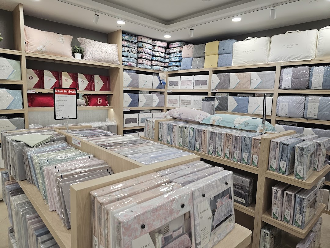 An interior view of Epitex, a bedding and home linen store, showcasing a wide array of pillows, duvets, and sheet sets.