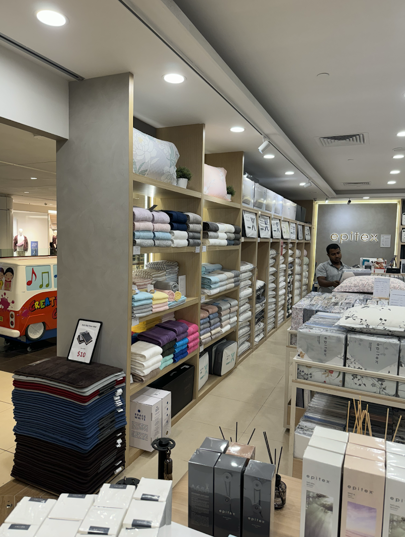 Interior view of Epitex, a home linen store, showcasing various bedding, towels, and home fragrance products.
