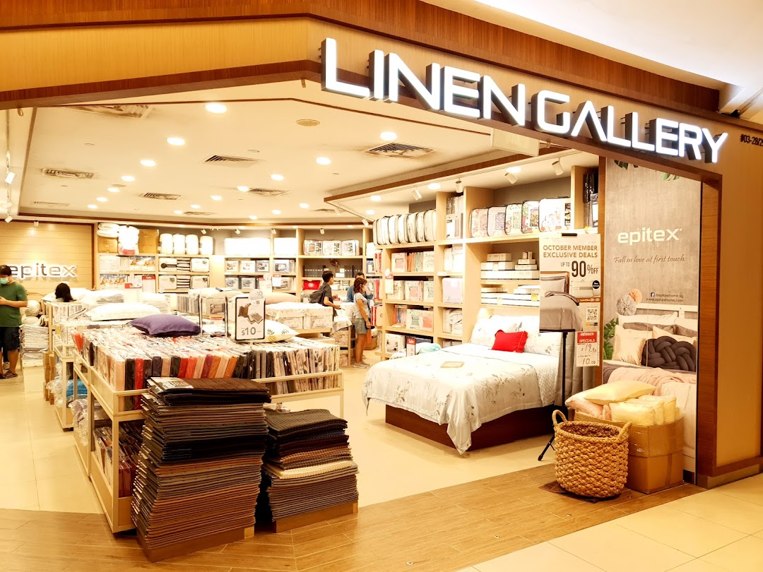 An interior view of Epitex Linen Gallery, showcasing a wide range of bedding, pillows, and home textiles.