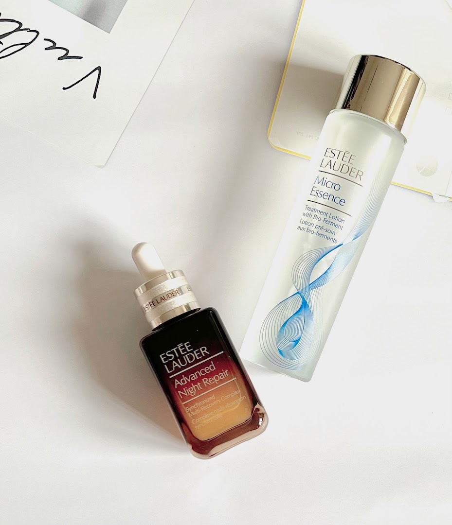 Two Estée Lauder skincare products, Advanced Night Repair serum and Micro Essence treatment lotion, displayed.