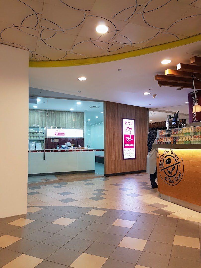 The entrance of Eu Yan Sang TCM Clinic, featuring its glass facade and signage, next to The Coffee Bean & Tea Leaf.