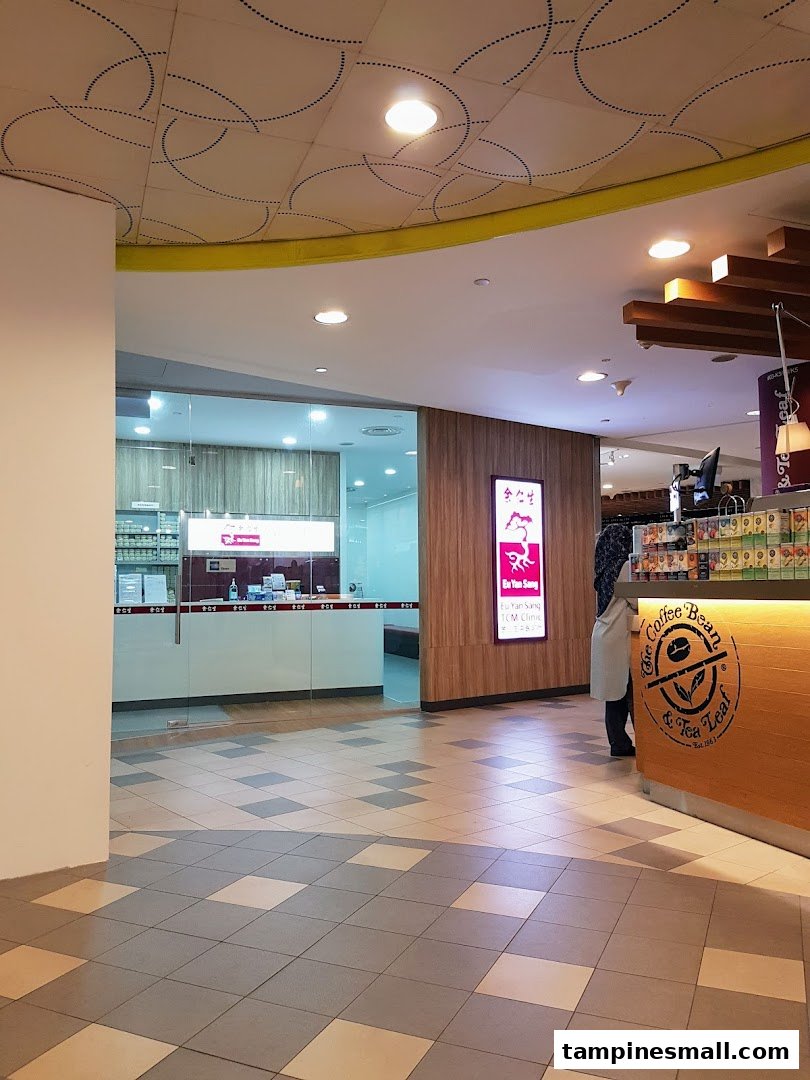The entrance of Eu Yan Sang TCM Clinic, featuring its glass facade and signage, next to The Coffee Bean & Tea Leaf.