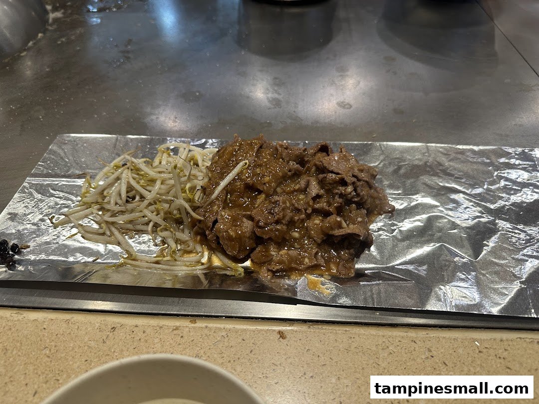 Delicious teppan-grilled meat and bean sprouts served on foil at Express Teppan-Yaki.