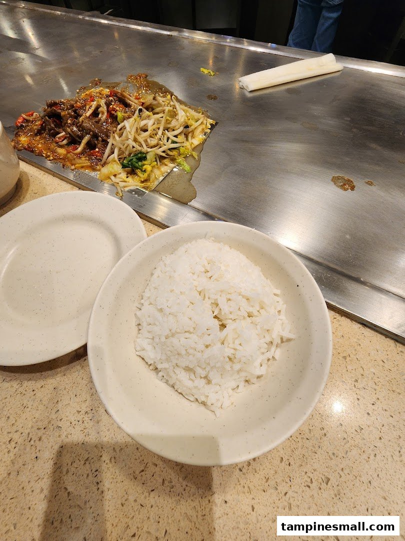Teppan-grilled beef and vegetables with a side of rice, ready to be served.