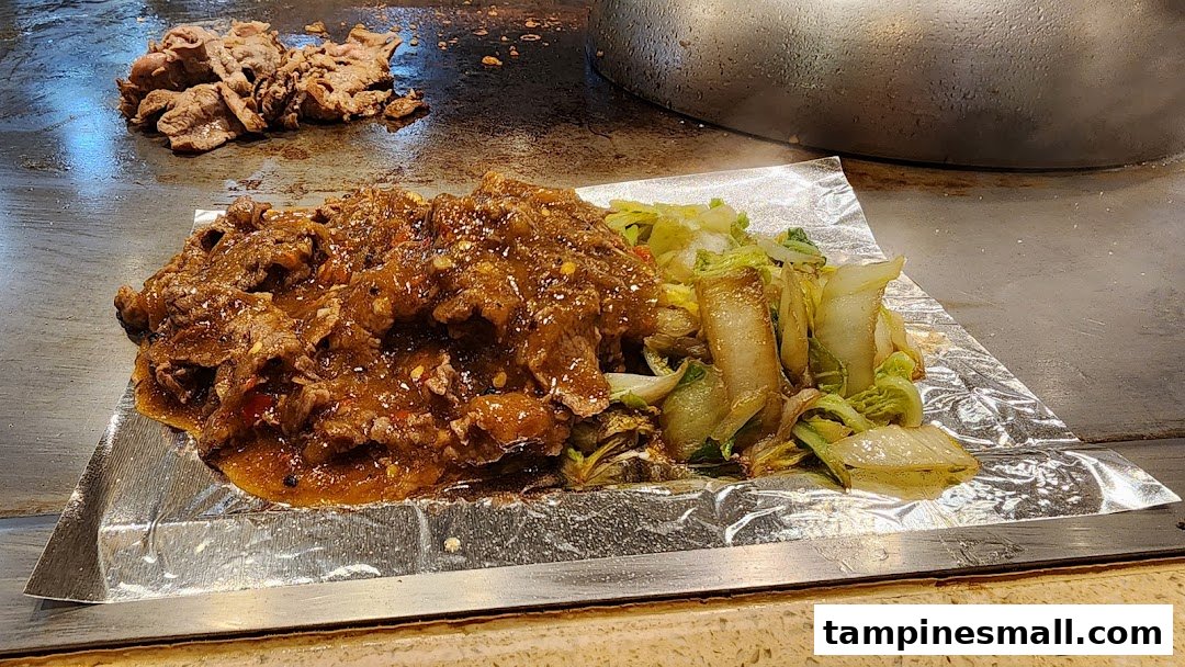Sizzling teppanyaki beef with vegetables served fresh off the grill on a hot plate.