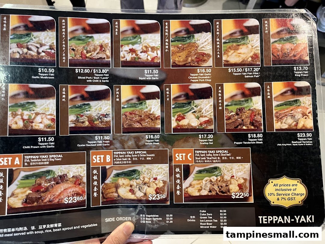 A detailed menu board displaying various Teppan-Yaki dishes, special sets, side orders, and drinks with prices.