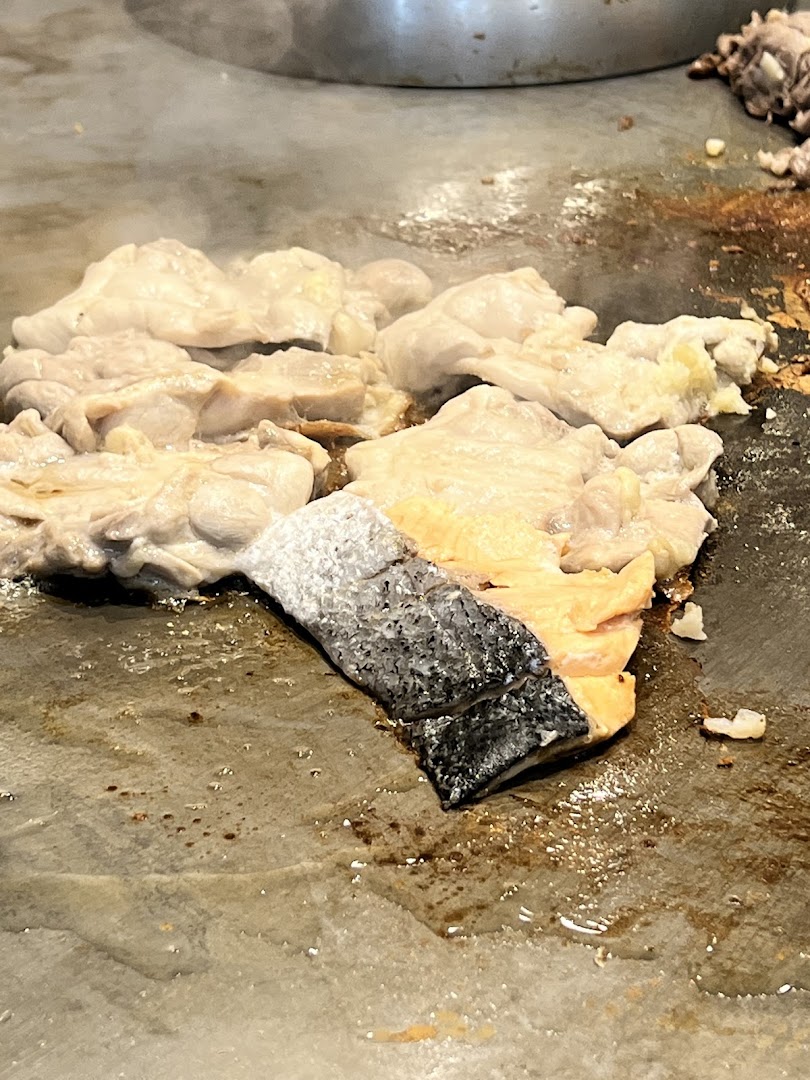 Fresh salmon and chicken sizzling on a hot teppan grill at Express Teppan-Yaki.