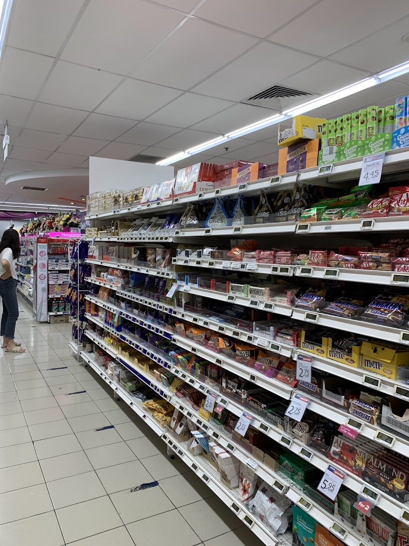 An aisle in FairPrice Tampines Mall featuring a wide selection of chocolates and snacks.
