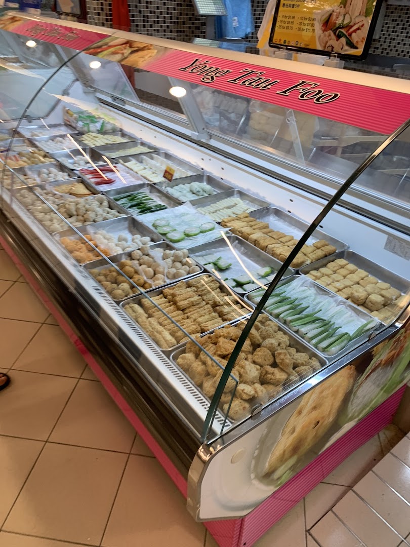 A vibrant display case filled with various Yong Tau Foo ingredients at FairPrice Tampines Mall.