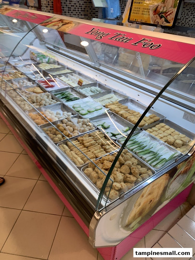 A vibrant display case filled with various Yong Tau Foo ingredients at FairPrice Tampines Mall.
