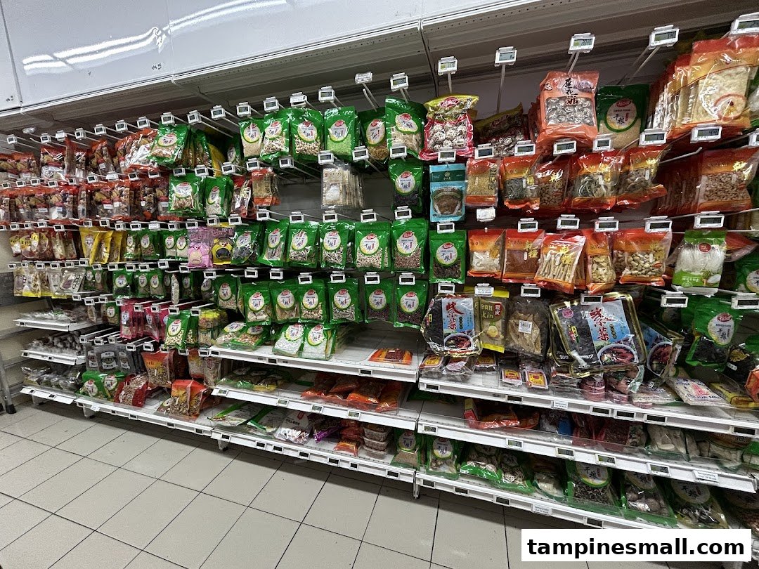 A well-stocked supermarket aisle displaying a wide variety of packaged dried goods, nuts, and spices.